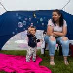 Aleisha Ashton watches as Kira Griffin, 1, plays with bubbles before the start of the Thunder on the Bay Fireworks at Legion Memorial Park on July 4 in Everett. See a photo gallery of the event <a href="https://www.heraldnet.com/news/gallery-everetts-waterfront-fireworks-show/" target="_blank">here</a>. (Olivia Vanni / The Herald)