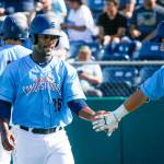 The Aquasox <a href="https://www.heraldnet.com/sports/stowers-brings-combination-of-speed-power-to-aquasox/" target="_blank">Josh Stowers</a> (25) gets a hand from teammate Bobby Honeyman after scoring a run as Everett took on Tri-City at Everett Memorial Stadium on June 24 in Everett. (Andy Bronson / The Herald)