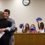 Eric Brossard receives a hug during drug court graduation as family and friends cheer in support at the Snohomish County Superior Court on Friday in Everett. (Olivia Vanni / The Herald)