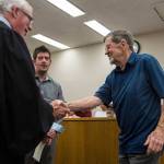 Judge Wilson shakes Rory Bossards hand as his son, Eric Bossard, graduates drug court at the Snohomish County Superior Court on Friday in Everett. (Olivia Vanni / The Herald)