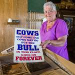 Audrey Young looks through a box of photos and mementos at Docs Pilchuck Tavern. (Olivia Vanni / The Herald)