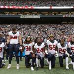Houston Texans players kneel and stand during the singing of the national anthem before an NFL game against the Seattle Seahawks in October in Seattle. The NFL Players Association has filed a grievance with the league challenging its national anthem policy. (AP Photo/Elaine Thompson, File)