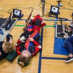 Kayla Dunham (from left), Jesse Brown and Reina Kim take a break during CMP Air Rifle Marksmanship Camp at Snohomish High School on Thursday. (Olivia Vanni / The Herald)