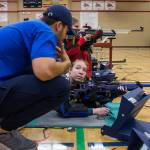 Sydney McKay listens as Shelby Huber gives her tips to improve her shooting during the CMP Air Rifle Marksmanship Camp at Snohomish High School on Thursday in Snohomish. (Olivia Vanni / The Herald)