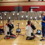 Maddie Korthas (right) talks to a camper during CMP Air Rifle Marksmanship Camp at Snohomish High School on Thursday. (Olivia Vanni / The Herald)