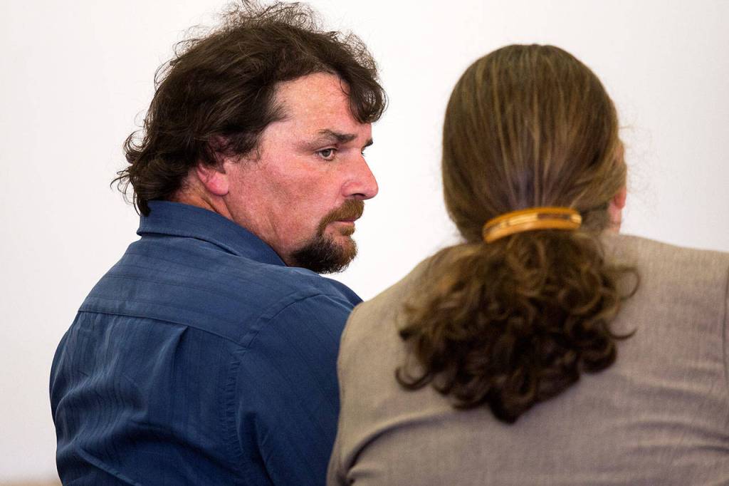Todd Eugene Brown, 52, listens to his attorney before he is found not guilty. (Andy Bronson / The Herald)