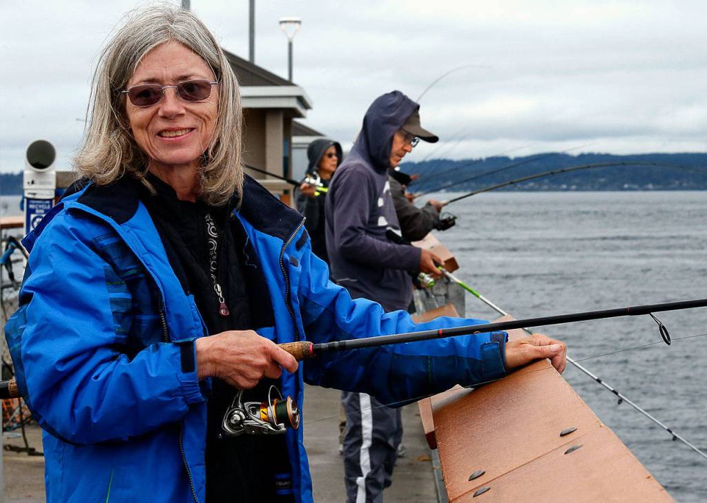 Valeda King loves to fish. She spends up to five hours a day at the public pier in Edmonds. (Dan Bates / The Herald)