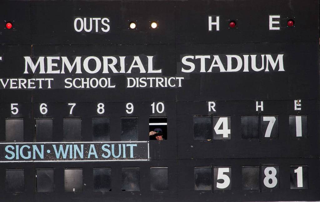 A person looks out from the scoreboard during the game at Everett Memorial Stadium on Sunday, July 15, 2018 in Everett, Wa. (Olivia Vanni / The Herald)