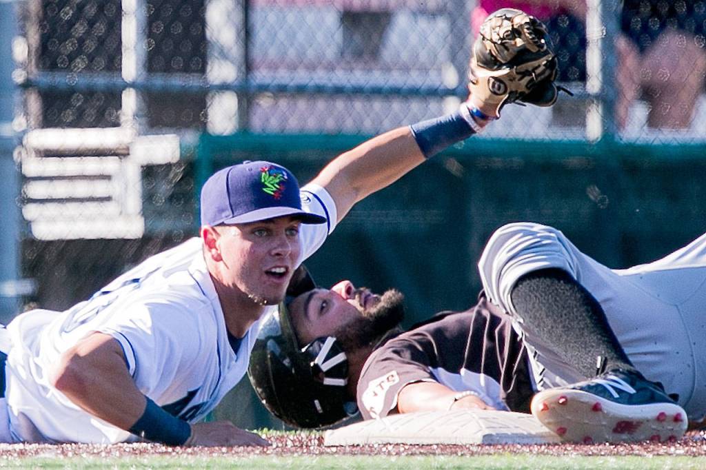 Aquasoxs Cash Gladfelter looks for the call after tagging Volcanos Medrona Robinson out at third Sunday afternoon at Everett Memorial Stadium on July 15, 2018. (Kevin Clark / The Herald)