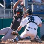 Aquasoxs Geoandry Motilla tags out Volcanos David Villar Sunday afternoon at Everett Memorial Stadium on July 15, 2018. (Kevin Clark / The Herald)