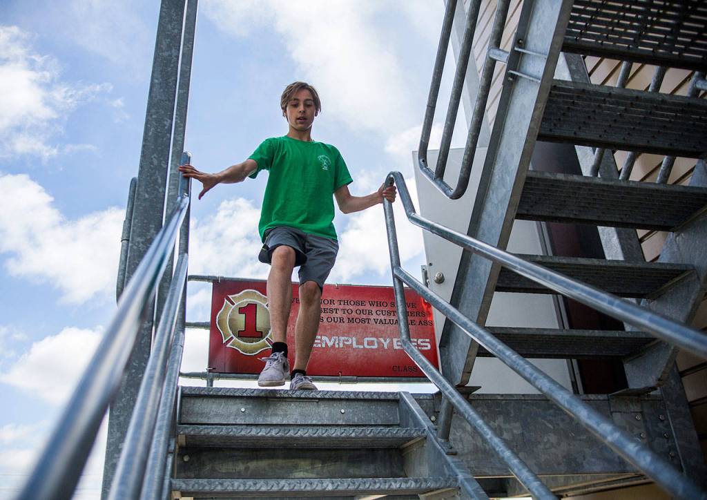 Alex Bonhan, 13, runs down the stairs of a training tower at the obsitcal course station during Kids Fire Camp at South County Fire Administrative Headquarters on Wednesday in Everett. (Olivia Vanni / The Herald)