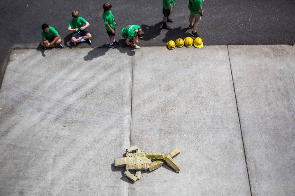 A fire hose dummy lies on the ground during Kids Fire Camp at South County Fire Administrative Headquarters on Wednesday in Everett. (Olivia Vanni / The Herald)