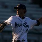 AquaSox pitcher Max Roberts throws a pitch in the setting sun against the Indians on July 17, 2018, at Everett Memorial Stadium. (Kevin Clark / The Herald)