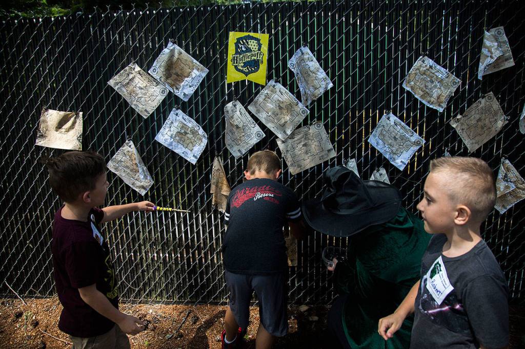 A group of boys cast spells with their newly made wands. (Olivia Vanni / The Herald)