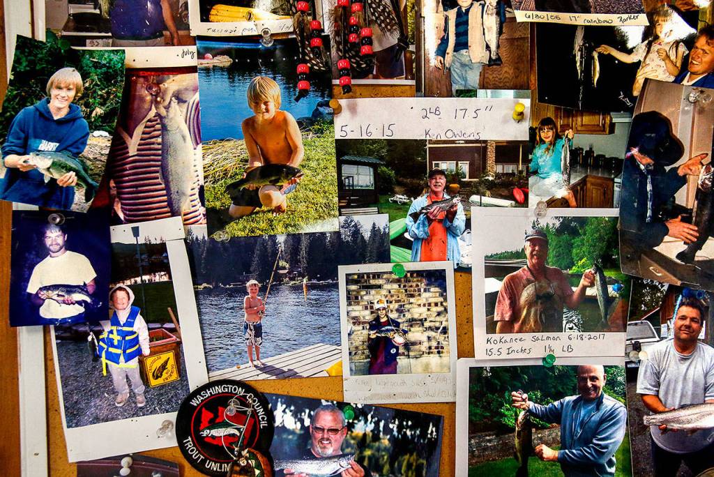 As is a custom at stores near good fishing lakes, a bulletin board covered with photos of people holding fish they caught hangs near the front door of the Lake Roesiger Store. (Dan Bates / The Herald)