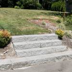 Steps leading to an empty lot are the remains of arson 10 years ago. (Kevin Clark / The Herald)