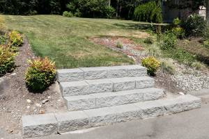 Steps leading to an empty lot are the remains of arson 10 years ago. (Kevin Clark / The Herald)
