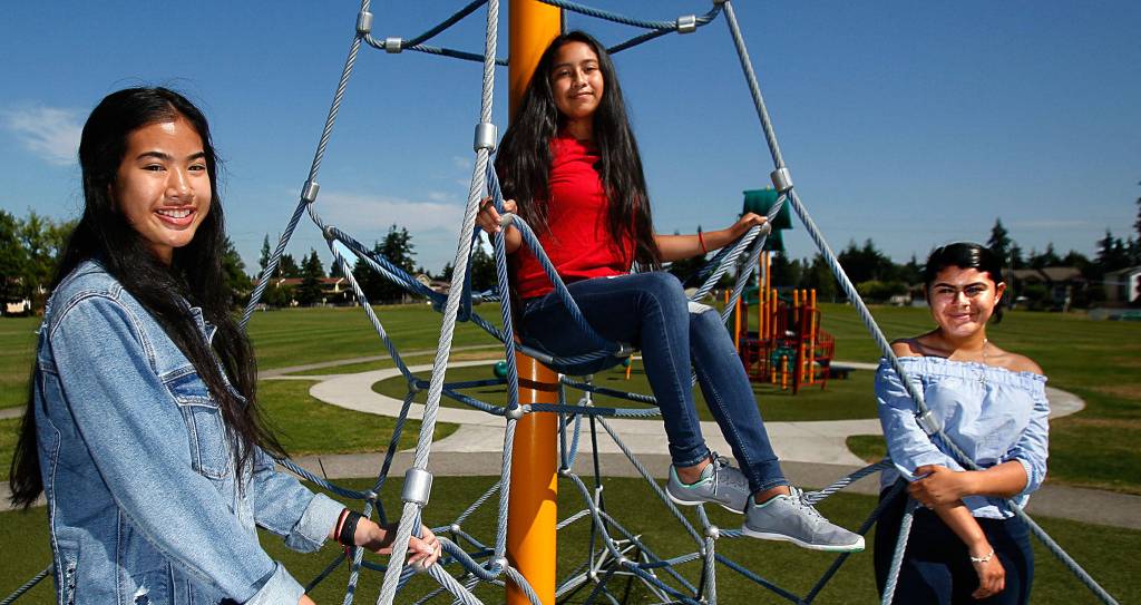 From left, Kayleen Yonn, 15, Brittany Mendez-Hernandez, 14, and Careana Willis, 15, meet at Walter E. Hall Park where they planned to help with Mobile Dental Day. (Dan Bates / The Herald)