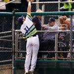 Aquasoxs Ryan Garcia reaches over the fence to make a leaping catch as the Everett Aquasox lost to the Spokane Indians 7-3 at Everett Memorial Stadium on July 18. (Andy Bronson / The Herald)