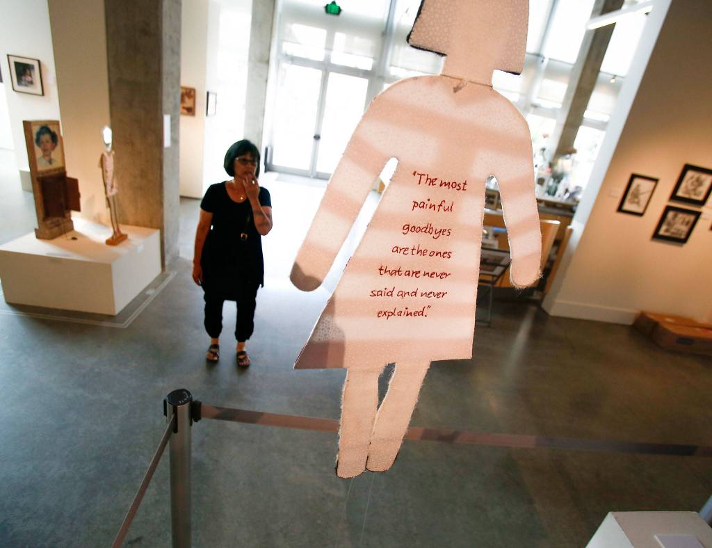 At the Schack Art Center, <a href="https://www.heraldnet.com/life/crying-visitors-reflect-on-americans-interned-exhibit/" target="_blank">co-Artist of the Year Jan Hopkins</a> looks over her displays on July 9. (Dan Bates / The Herald)
