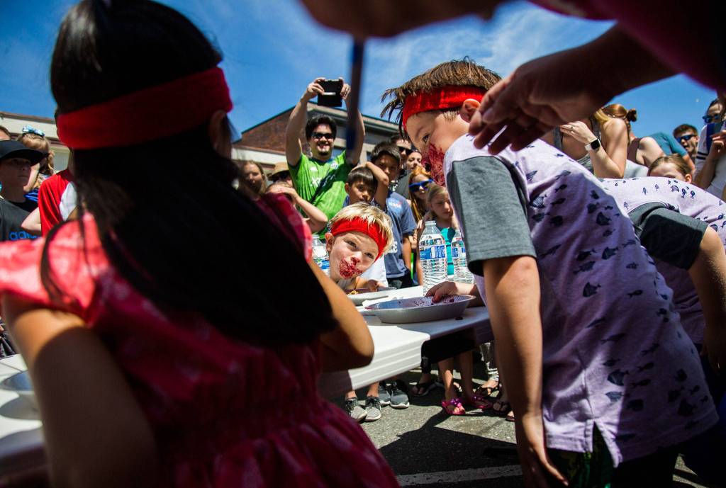 Oliver Strasser, 5, looks up from eating his pie during the pie eating contest at Kla Ha Ya Days on Saturday, July 21, 2018 in Snohomish, Wa. (Olivia Vanni / The Herald)