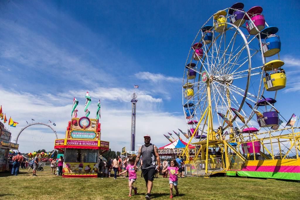 People walk around the carnival during Kla Ha Ya Days on Saturday, July 21, 2018 in Snohomish, Wa. (Olivia Vanni / The Herald)