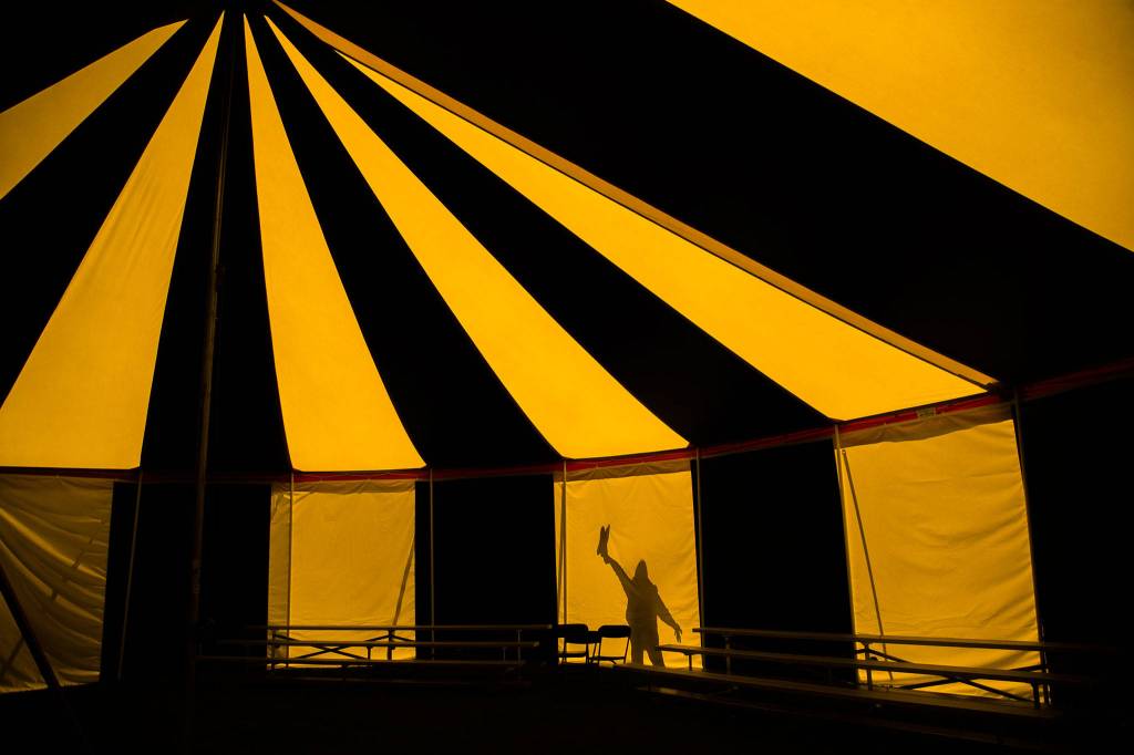 Vuelta La Luna circus troupe ring master, Jason Barker, is silhouetted against the circus tent during Kla Ha Ya Days on Saturday, July 21, 2018 in Snohomish, Wa. (Olivia Vanni / The Herald)