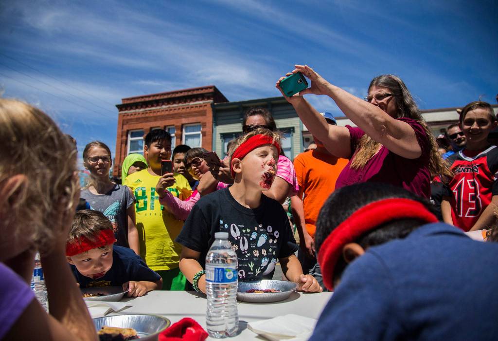 Clavin Roberts, 8, lifts his head to try to swallow a large piece of pie crust during the pie eating contest at Kla Ha Ya Days on Saturday, July 21, 2018 in Snohomish, Wa. (Olivia Vanni / The Herald)