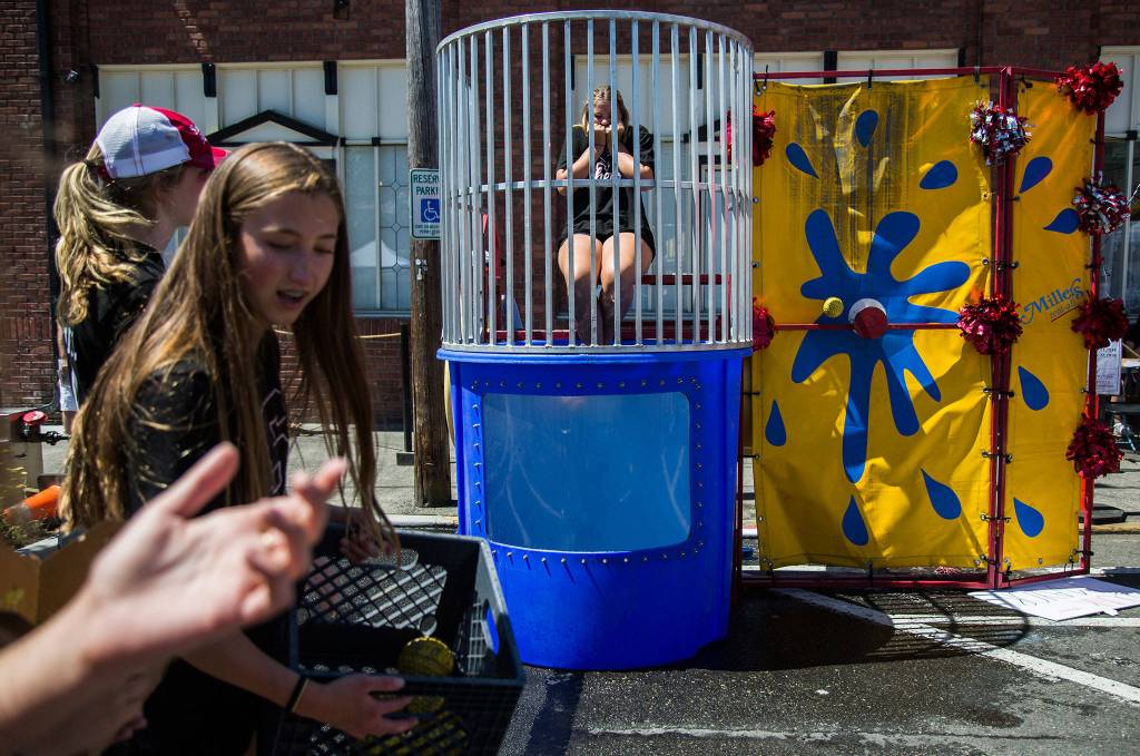 Jenelle Corneliaon flinches as a ball misses the dunk tank target during Kla Ha Ya Days on Saturday, July 21, 2018 in Snohomish, Wa. (Olivia Vanni / The Herald)