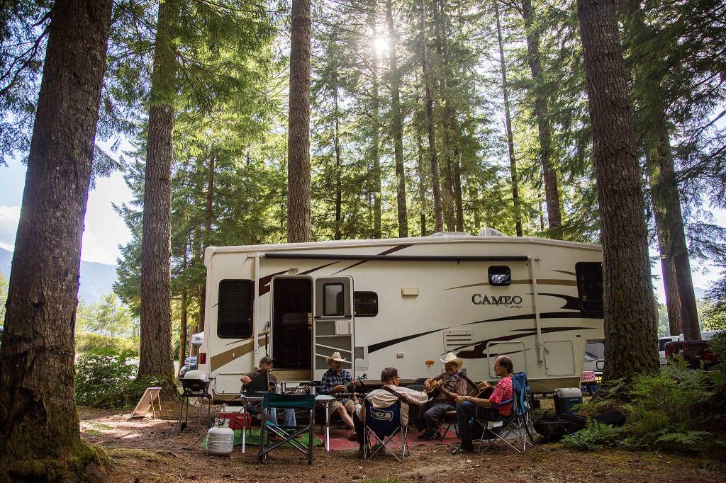 A group of festival campers gather for jam session a during the Darrington Bluegrass Festival on Saturday, July 21, 2018 in Darrington, Wa. (Olivia Vanni / The Herald)
