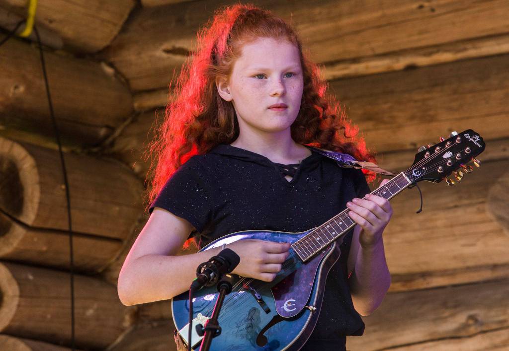 Rayna Conley of the Huckleberries plays on stage during open mic at the Darrington Bluegrass Festival on Saturday, July 21, 2018 in Darrington, Wa. (Olivia Vanni / The Herald)