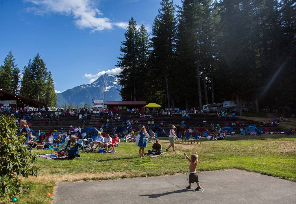 People gather to watch performers during the Darrington Bluegrass Festival on Saturday, July 21, 2018 in Darrington, Wa. (Olivia Vanni / The Herald)