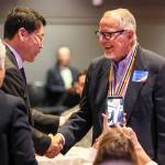 Kenneth Strum (right) shakes hands with Consul General Hyung-jong Lee after being presented his Ambassador for Peace Medal on Monday morning at Northwest Church in Lynnwood. (Kevin Clark / The Herald)