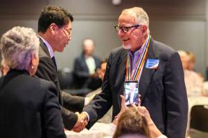 Kenneth Strum (right) shakes hands with Consul General Hyung-jong Lee after being presented his Ambassador for Peace Medal on Monday morning at Northwest Church in Lynnwood. (Kevin Clark / The Herald)