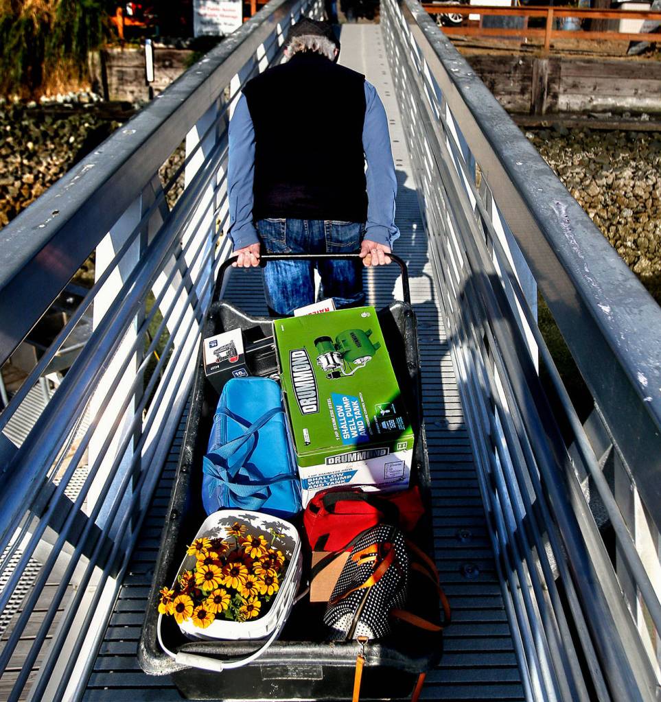 When islanders return on the Hat Express, they often have some serious hauling to do, getting purchased supplies back to their island homes. (Dan Bates / The Herald)