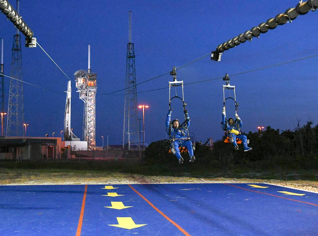Chris Ferguson and Suni Williams practice an emergency escape from the crew access tower at Launch Complex 41 at the Kennedy Space Center in Florida. (Jonathan Newton/Washington Post)