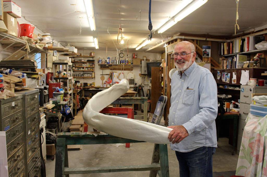 Woodworker Ken Price spent months restoring the jaw bone of a blue whale that had deteriorated outside Langelys Whale Center. (Patricia Guthrie / Whidbey News Group)