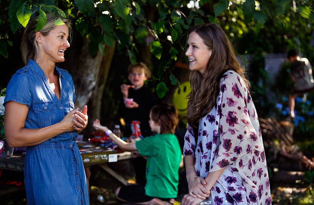 As the kids enjoy a Popsicle party at the picnic table, Lisa Marquart, 45 (left) and Jacqy Vorderbrueggen, 27, talk about Vorderbrueggens 8-year-old son, Quintin Hall (green shirt.) (Dan Bates / The Herald)