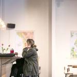 Natanya Bruzzesse-Colley sits at the counter on a recent afternoon at Farms & Market in Everett. (Kevin Clark / The Herald)