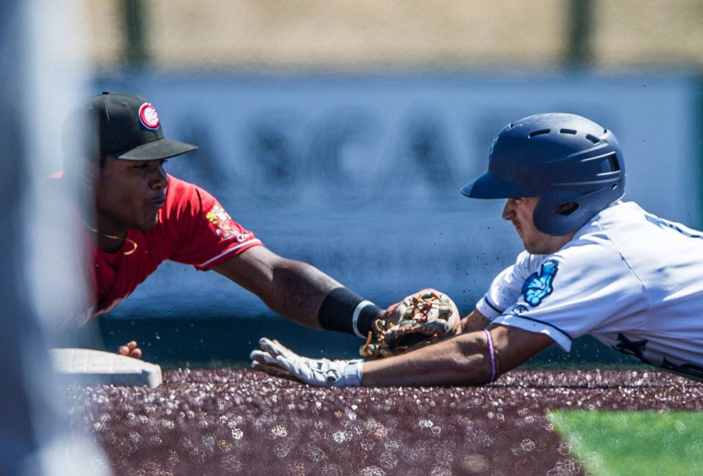 Aquasoxs Ryne Ogren is tagged out by Vancouvers Jesus Severino as he slides into second base during the game at Everett Memorial Stadium on Thursday, July 26, 2018 in Everett, Wa. (Olivia Vanni / The Herald)
