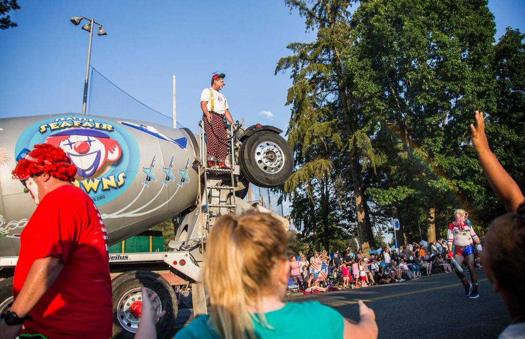 A Safari clown create a rainbow with his water spray during the Tour de Terrace parade on Friday, July 27, 2018 in Mountlake Terrace, Wa. (Olivia Vanni / The Herald)