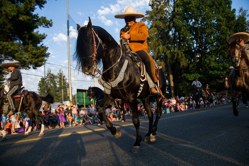 Domingo Garcia rides his horse El Mandilos during the Tour de Terrace parade on Friday, July 27, 2018 in Mountlake Terrace, Wa. (Olivia Vanni / The Herald)