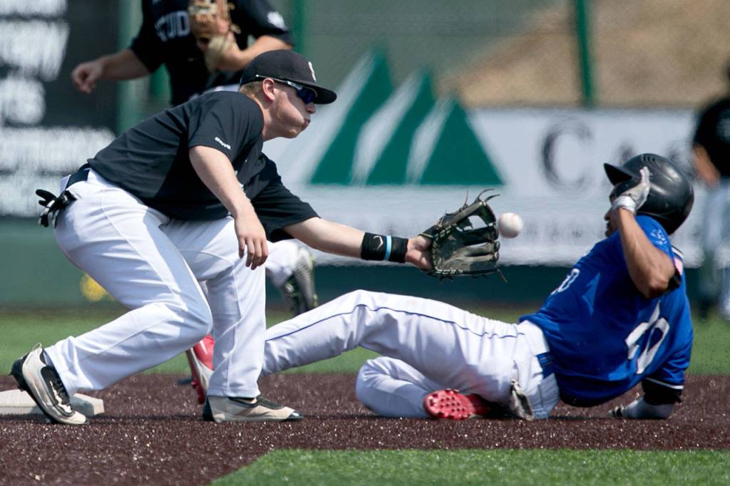 Everetts CJ Hicks beats the throw to second base as Seattles Collin Wolf applies the tag during the Merchants July 28 game against the Cheney Studs at Everett Memorial Stadium. (Kevin Clark / The Herald)