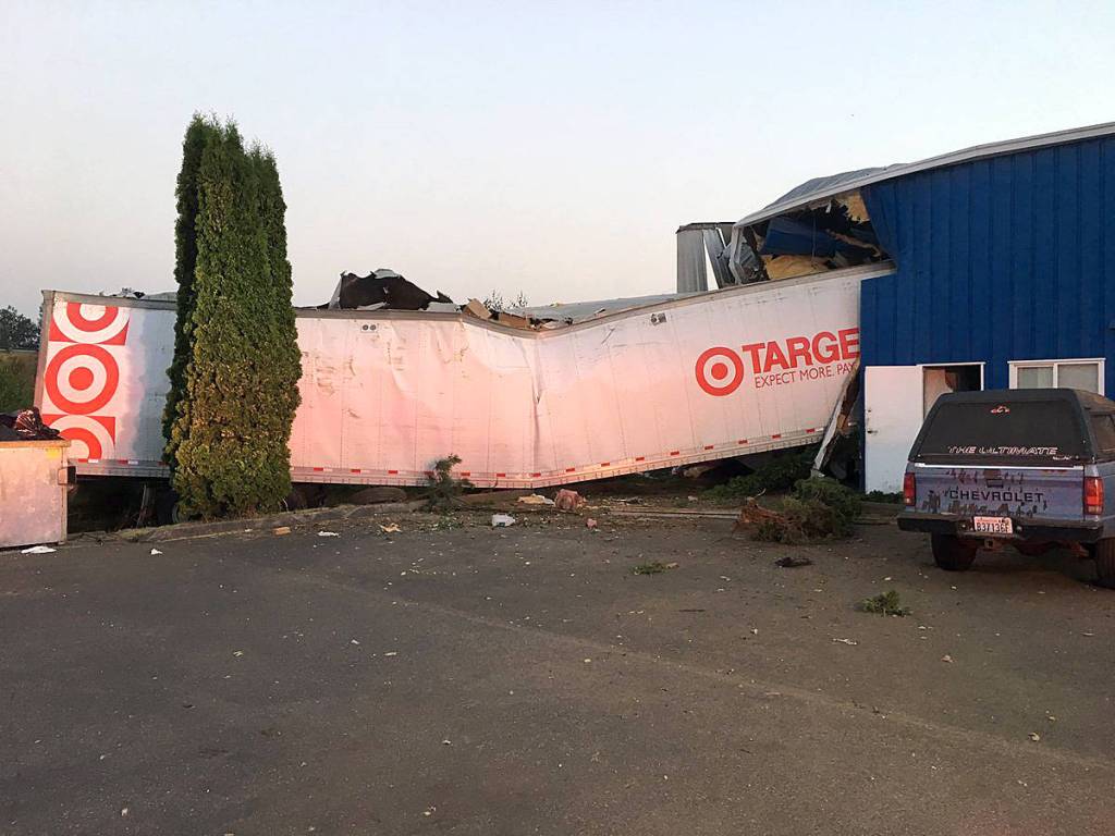 Driver hospitalized after crashing semi into building