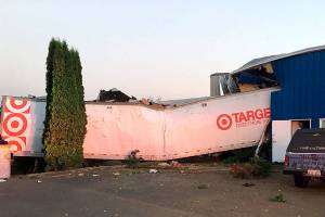 Driver hospitalized after crashing semi into building