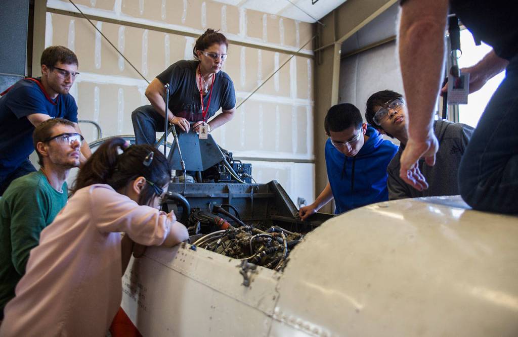 Students listen while teacher Dale Lerback explains what they should be checking before they remove the Viper engine during class at Everett Community Colleges Aviation Maintenance Technician School on Friday, July 13, 2018 in Everett, Wa. (Olivia Vanni / The Herald)