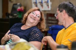 Cathy Currie (left) shares a laugh with Bob Seaman during the weekly meet up of the Knit Wits and Happy Hookers at the Carl Gipson Senior Center Thursday afternoon in Everett on July 26, 2018. (Kevin Clark / The Herald)