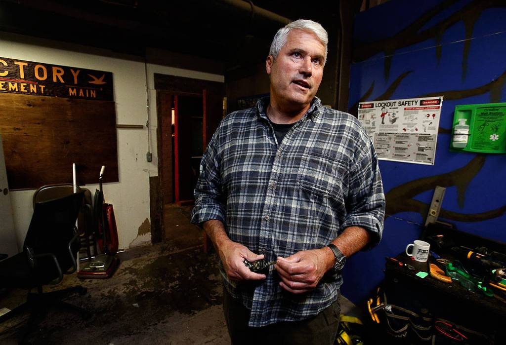 Chandler Williamson, an Everett Recovery Cafe board member, pauses during a walk through the nonprofits new home and talks about his own struggles with alchohol and drugs as a younger man. (Dan Bates / The Herald)