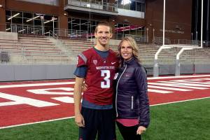 Kym Hilinski with her son, Tyler, on the field at Washington State Universitys Martin Stadium. Tyler, a 21-year-old WSU quarterback, took his life in January. His mother will be at the Everett AquaSox game Saturday to raise awareness of Hilinskis Hope, a nonprofit the family founded to address mental health issues and honor Tyler.