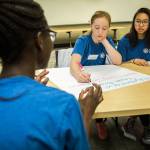 Alberta Gbla ( from left) talks with Aleksandra Kogalovski and Nina Huynh, of Mariner High School, during the Fred Hutch Pathway Research Explorers Program at the Fred Hutchinson Cancer Research Center on Aug. 9 in Seattle. (Olivia Vanni / The Herald)